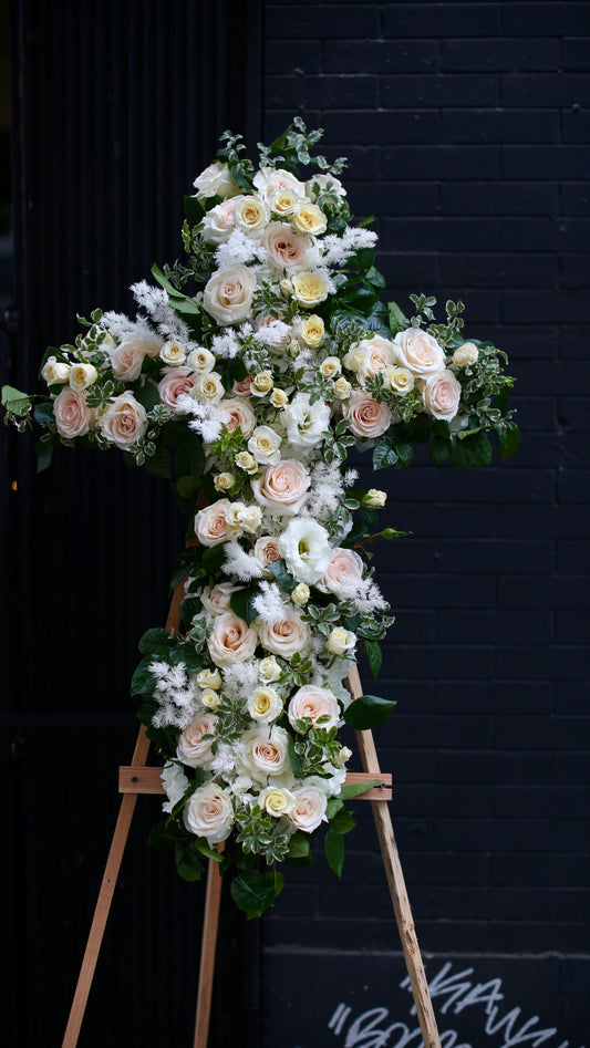 Elegant floral arrangement of white lilies, symbolizing peace and remembrance