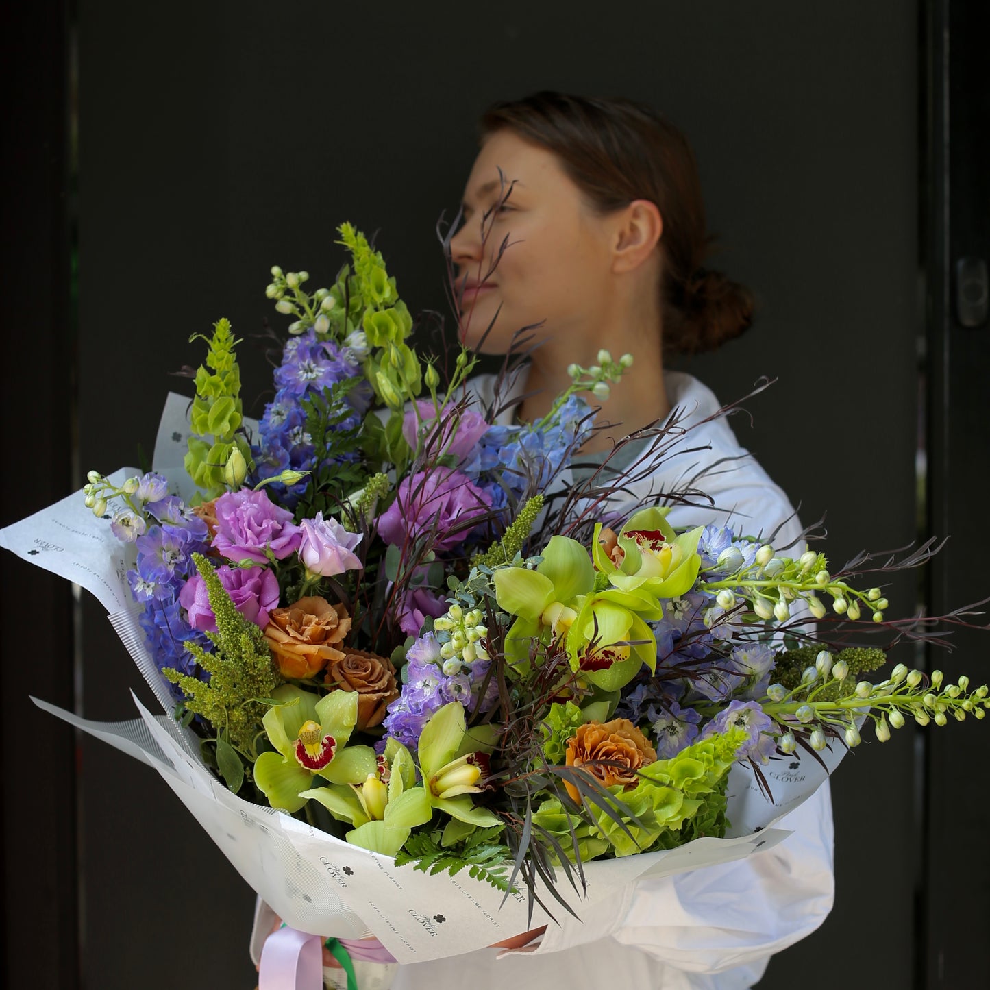 Luxurious green bouquet with roses and anthuriums, styled for modern elegance