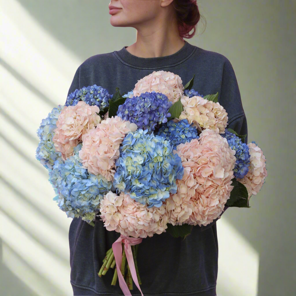 Elegant bouquet of blush flowers with lush green accents, ideal for serene celebrations