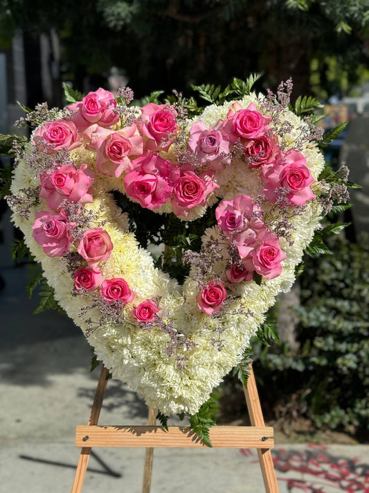 Heart-shaped sympathy bouquet with pink roses and peonies, symbolizing compassion and remembrance