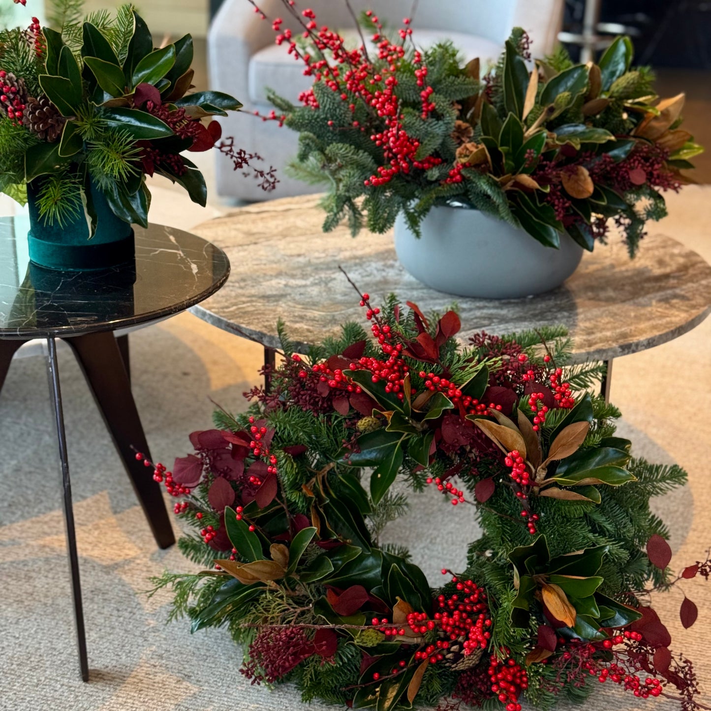 Festive bouquet of red roses and white lilies with seasonal greenery, perfect for holiday celebrations