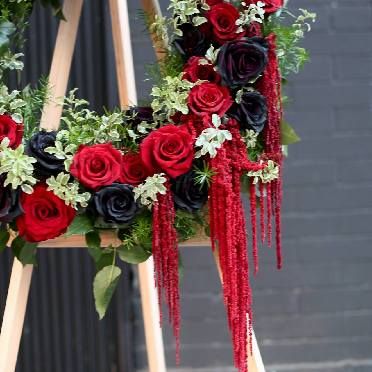 Memorial Bloom from Pink Clover LA, featuring delicate white flowers and green accents