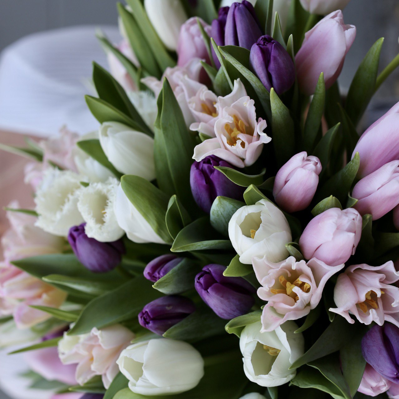 A handmade Hazel floral gift featuring fresh tulips in a bright yet cheerful presentation for luxurious delivery.
