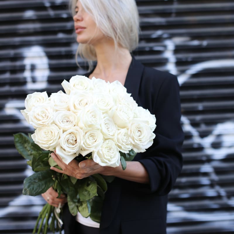 Elegant bouquet of white roses with lush green accents, ideal for serene celebrations