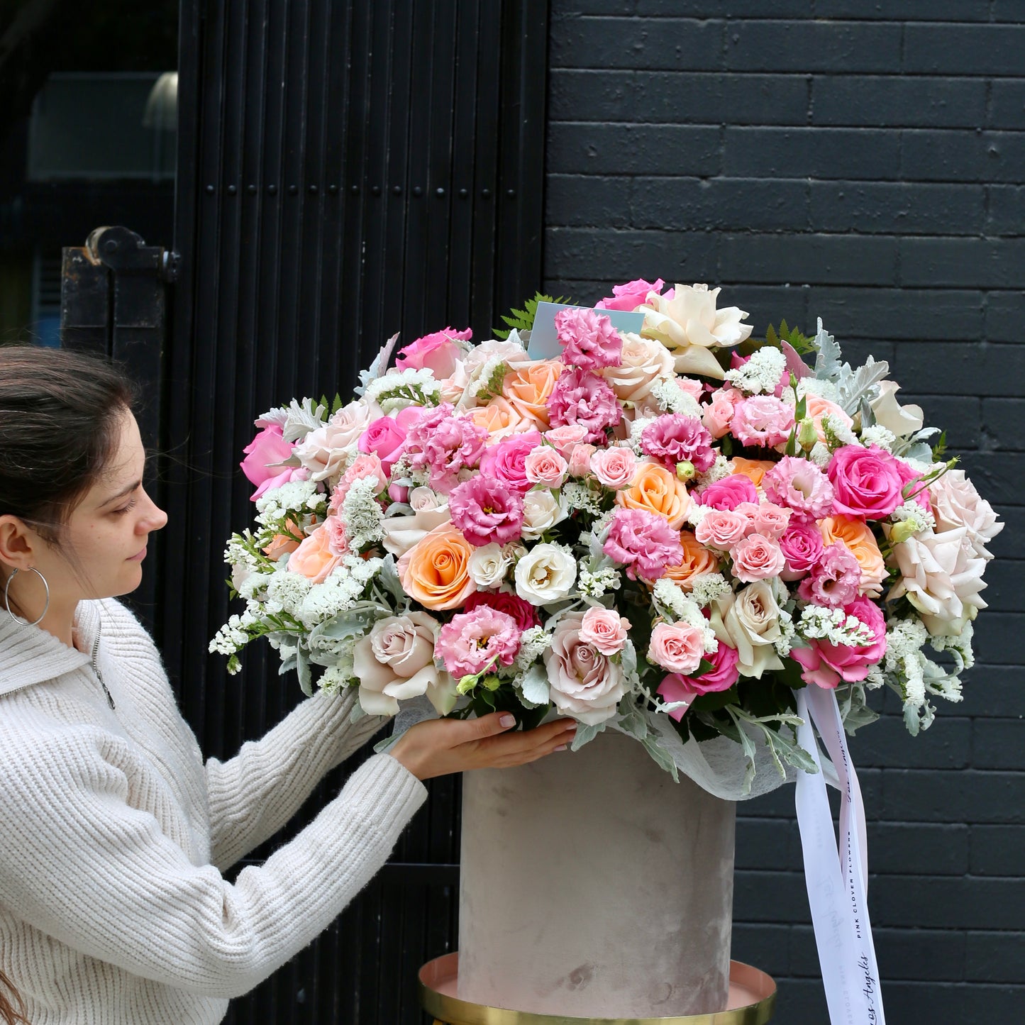 Dreamy pink flower bouquet with roses, carnations, and greenery wrapped in kraft paper and satin ribbon — Pink Cloud by Pink Clover LA.