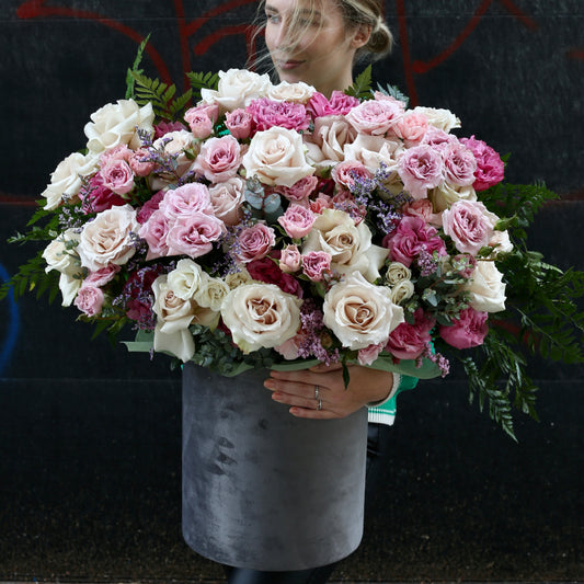 Pastel pink and white rose bouquet with lush greenery, wrapped in ivory satin ribbon — Rosy Garden by Pink Clover LA.