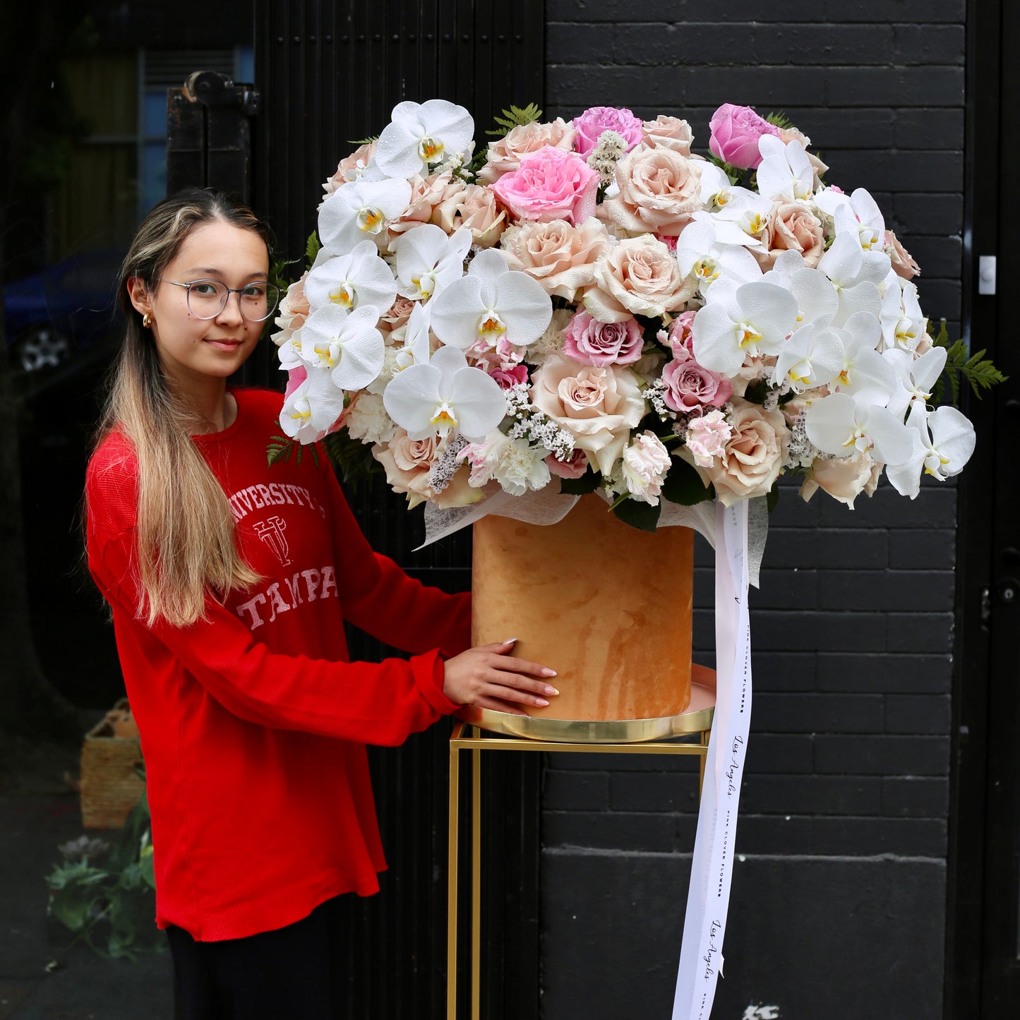 Elegant flower arrangement in a decorative box with roses, spray blooms, and greenery – Lovely Box by Pink Clover LA.