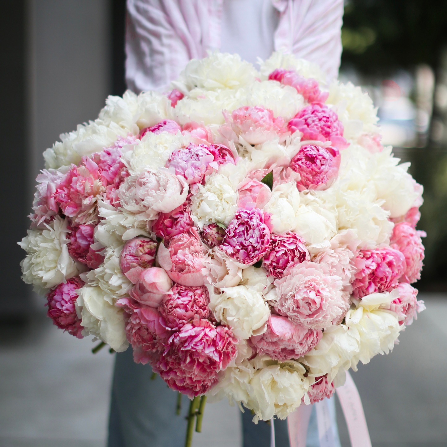 Fresh 100 Peonies bouquet from Pink Clover LA, styled with cascading petals and green accents