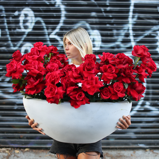 Luxurious bouquet of red roses and greenery, symbolizing eternal love and devotion
