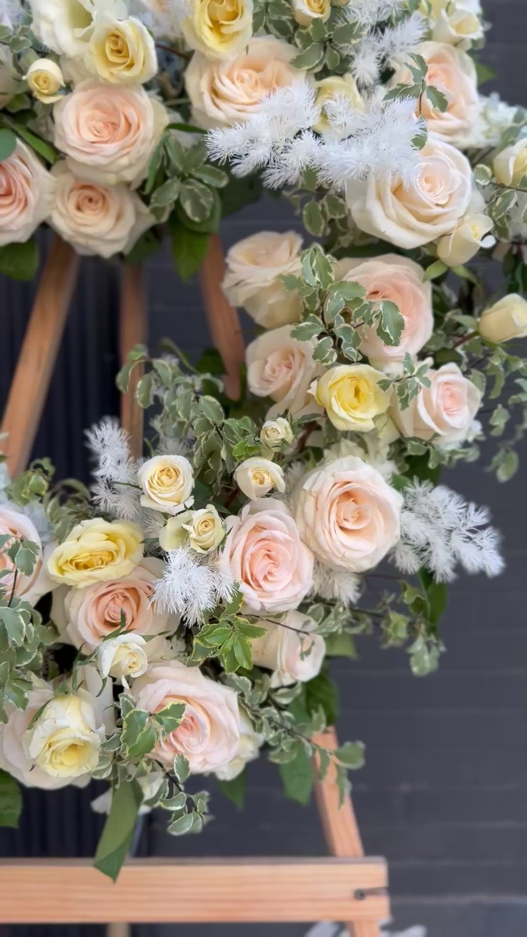 Vibrant floral arrangement featuring long-stemmed red roses and lush greenery