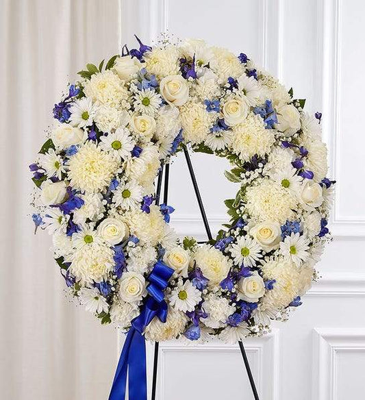 Elegant Circle Spray Blue standing wreath with blue and white flowers, ideal for funeral services and premium floral delivery