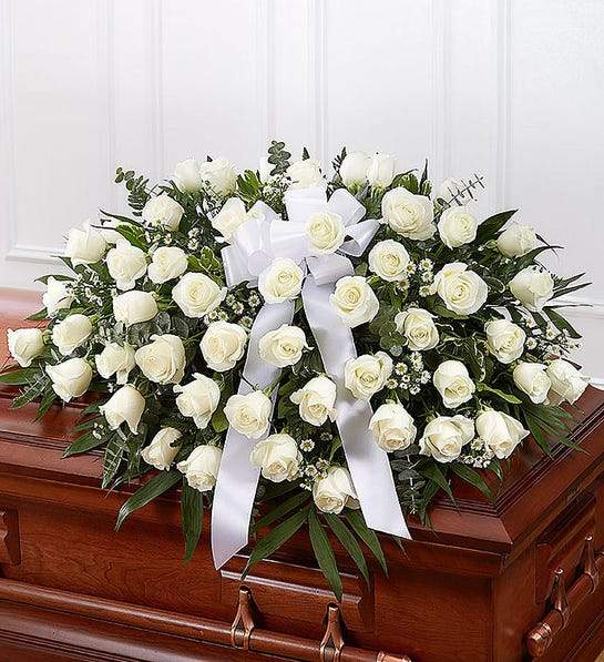 Serene Casket Cover Memory featuring white roses and Monte Casino blooms, elegantly arranged for funeral tributes and premium floral delivery
