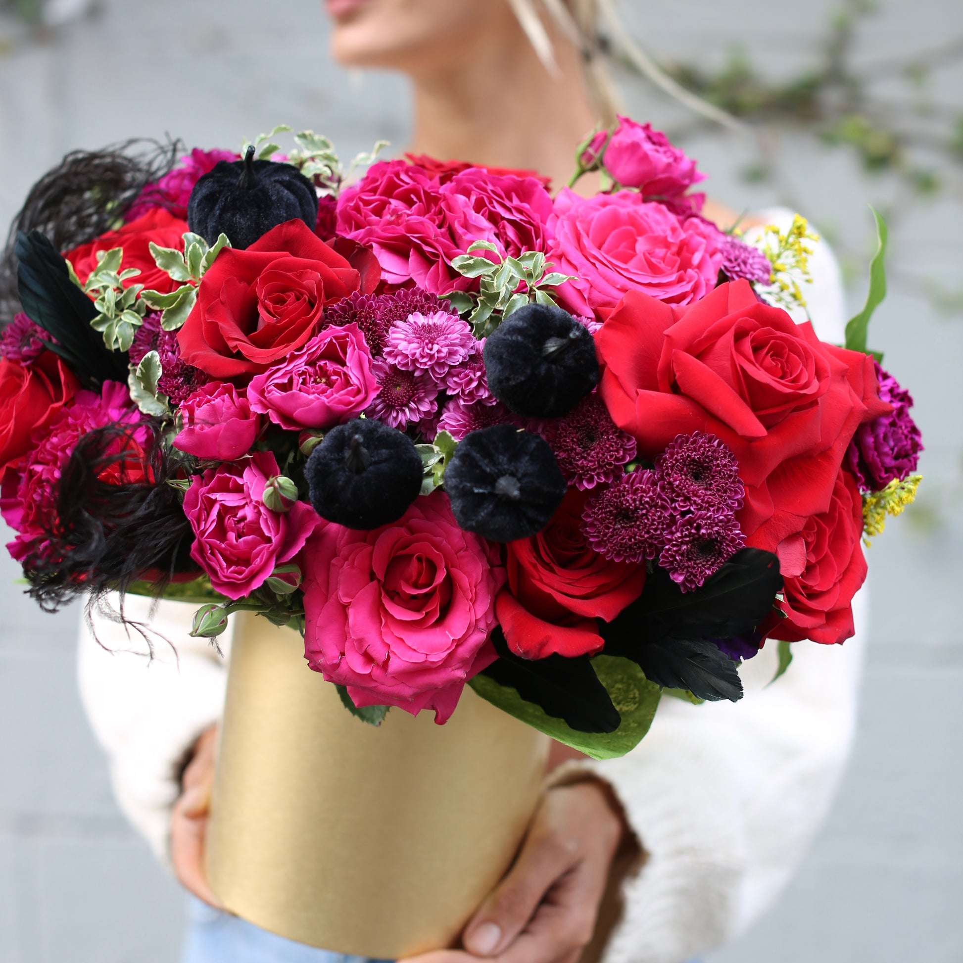 Elegant red and purple rose arrangement styled in a gold keepsake box, ideal for fall celebrations and premium floral delivery