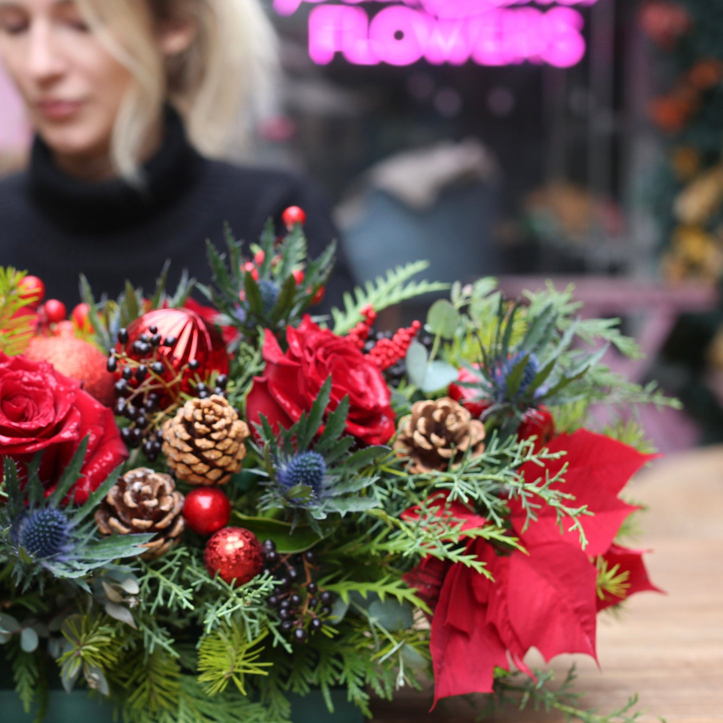 Luxurious holiday floral arrangement with white blooms and natural accents, ideal for Christmas table decor