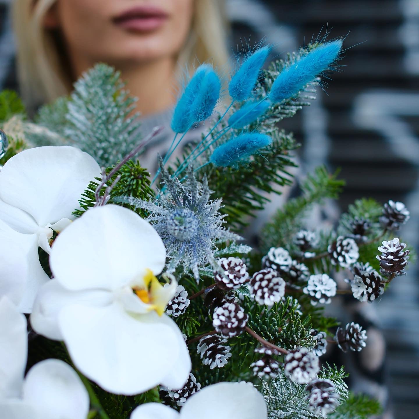Beautifully styled Christmas bouquet with pine, orchids and soft accents, ideal for premium gifting and seasonal décor