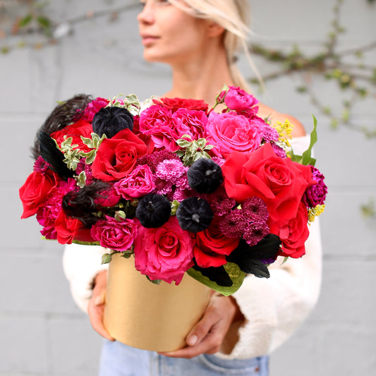 Luxurious Halloween bouquet featuring red roses, purple chrysanthemums and velvet pumpkins in a decorative gold pumpkin box