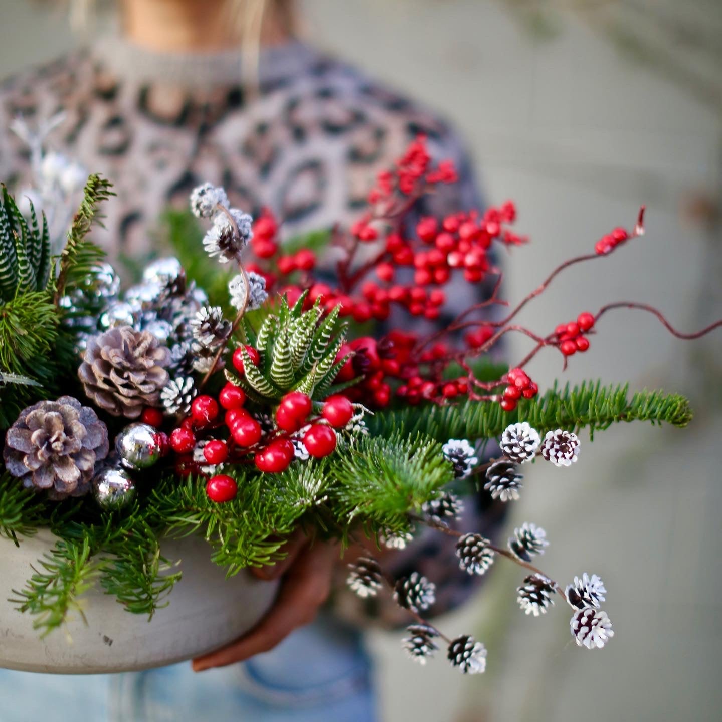 Elegant Winterberry bouquet with red berries and decorative succulents, beautifully presented for premium delivery