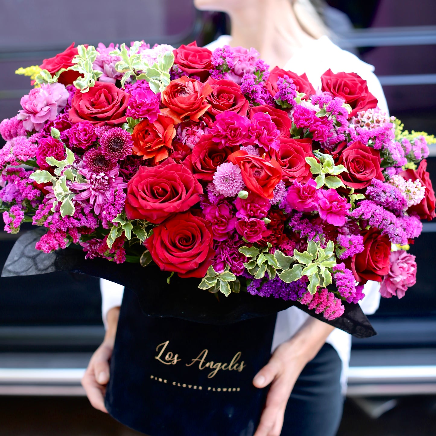 Luxurious red rose bouquet with mixed flowers arranged in a decorative gift box – ideal for romantic gifting and premium floral delivery