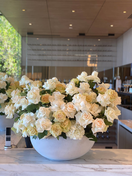 Elegant Noble bouquet showcasing white and beige roses beautifully arranged in a modern gray vase for premium floral delivery
