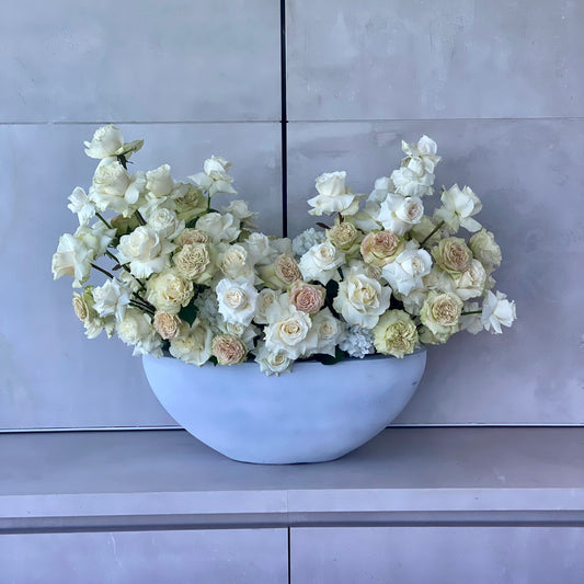 Elegant Majestic bouquet showcasing white and beige roses beautifully arranged in a modern gray vase for premium floral delivery
