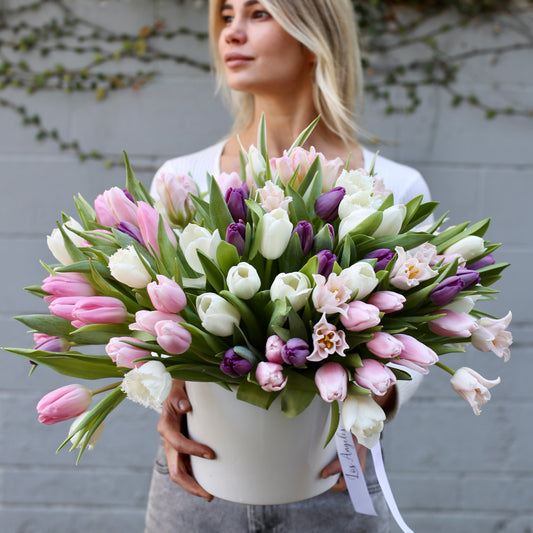 Vibrant bouquet of 100 mixed tulips in soft and bold tones, beautifully arranged for luxury gifting