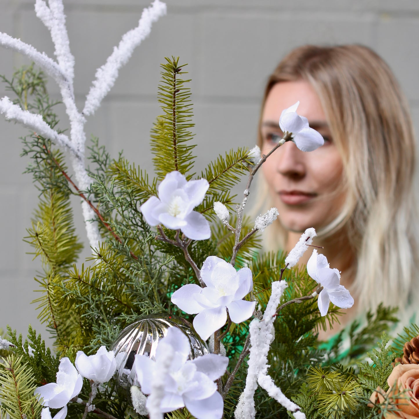Beautifully styled holiday Christmas tree with fresh flowers and earthy accents, ideal for luxury home celebrations