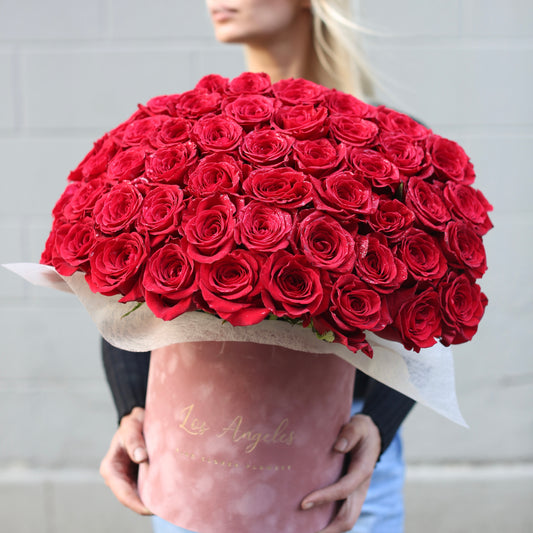 Luxurious velvet box filled with 50 fresh red roses, beautifully arranged for a romantic and elegant gifting experience