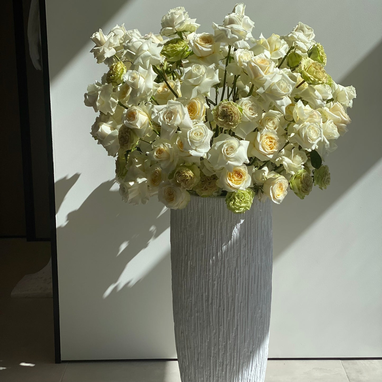 Luxurious Prestige bouquet featuring white and beige roses arranged in a tall elegant vase, perfect for upscale floral gifting