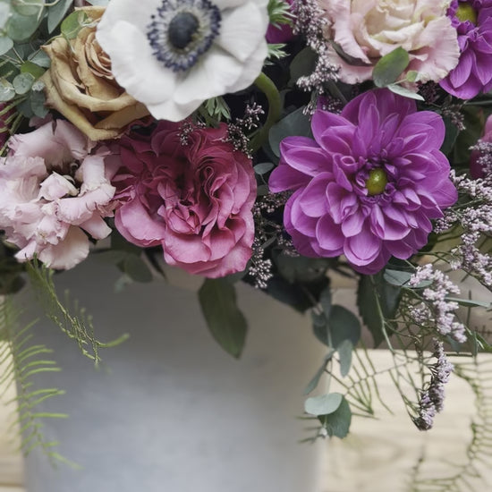 Handcrafted floral composition with dramatic anemones and complementary blooms, arranged in a refined aesthetic